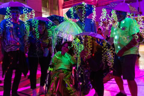 Participants dressed in Halloween costumes dance together