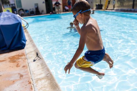 Young swimmer jumps into Ortega Park Pool