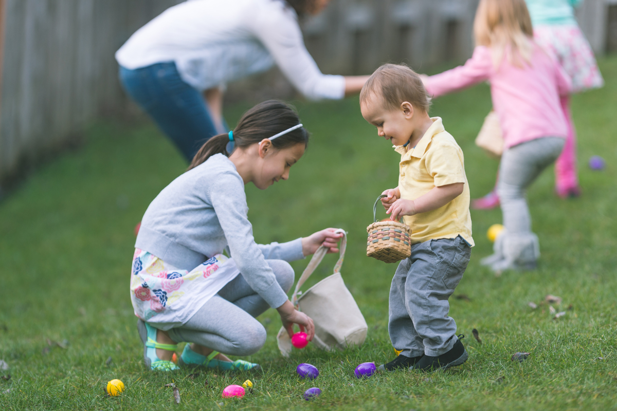 Kids picking up Easter Eggs from the grass